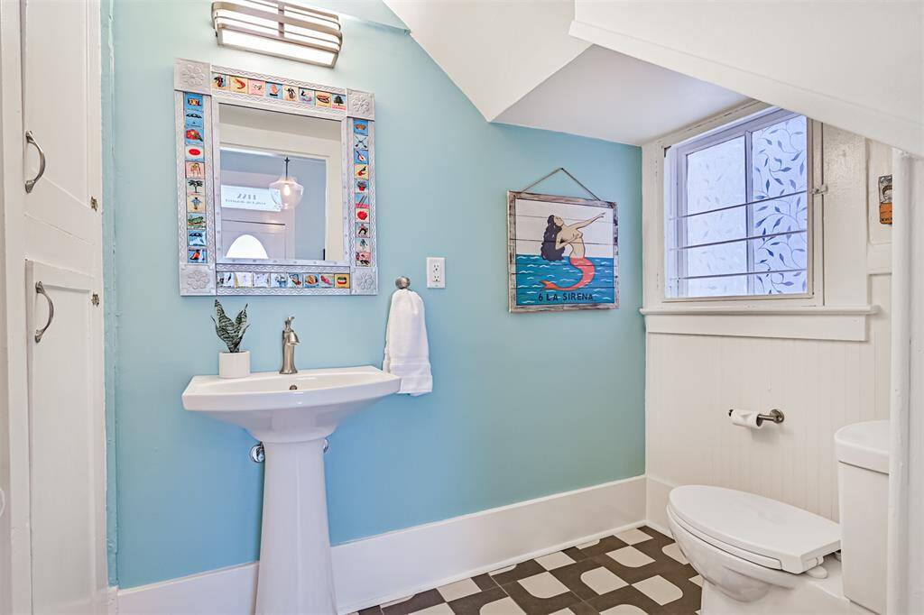 Half Bath features custom cabinetry for extra storage.