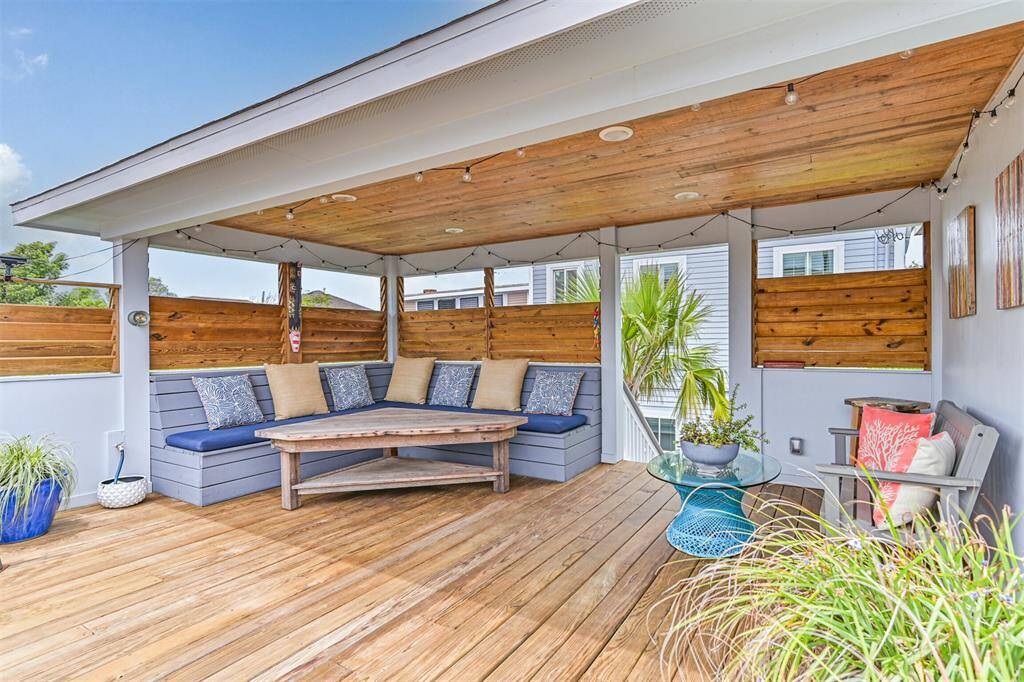 Built-in custom seating with moveable wooden privacy screen louvers.
