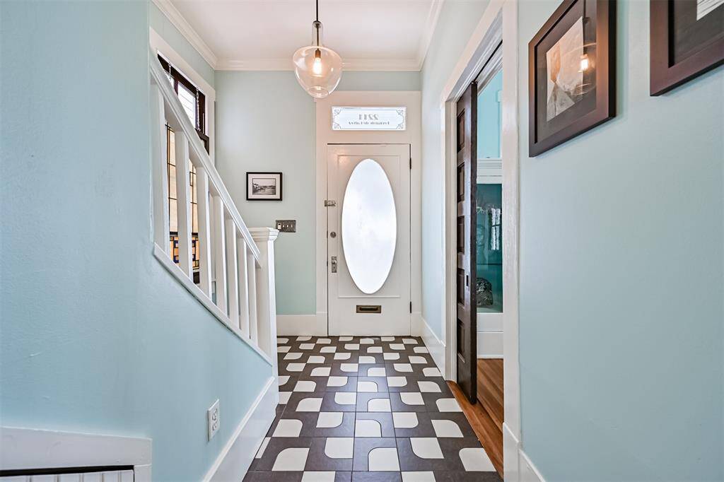 Front entry features an original historic front door and a pocket door to the right which leads to the living room.