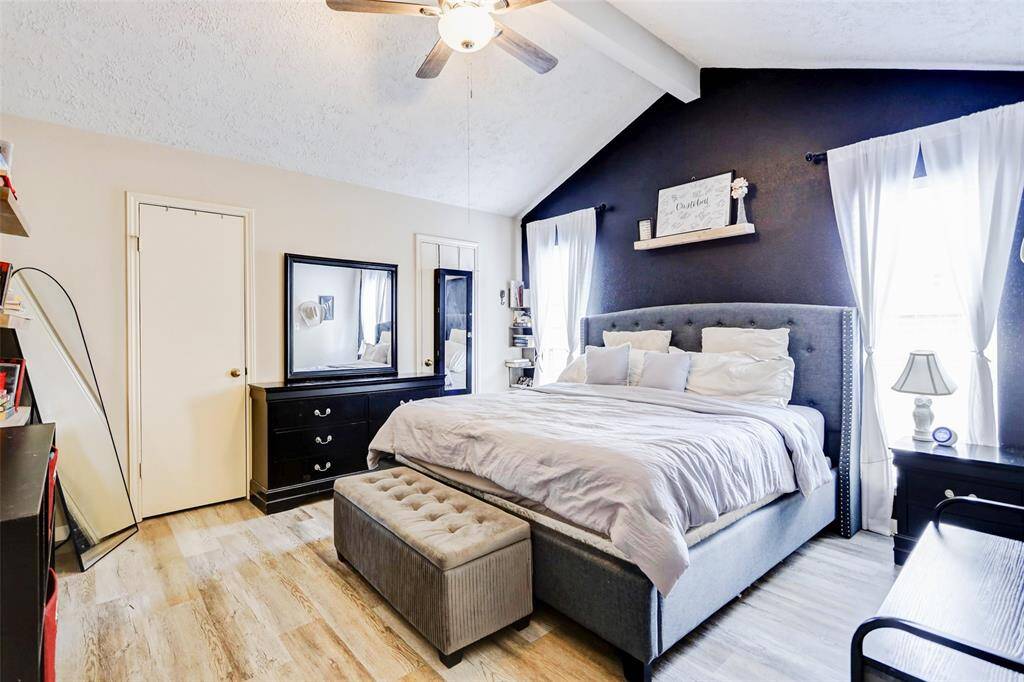 Spacious primary bedroom with double closets and vaulted ceiling