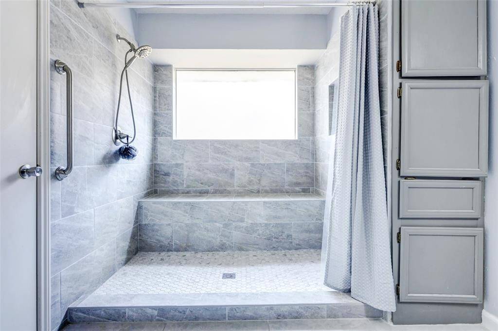 Spacious walk in shower with frosted glass for privacy