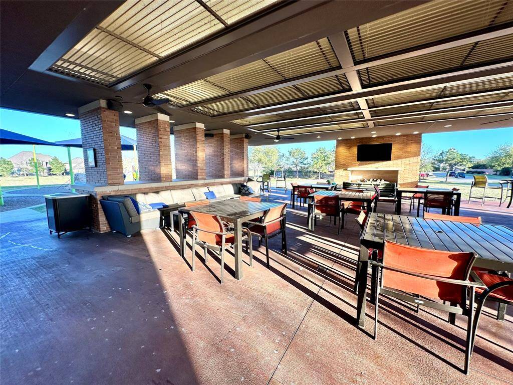 Enjoy watching the sunset on this extended covered patio with cozy fireplace. Next to the pool.