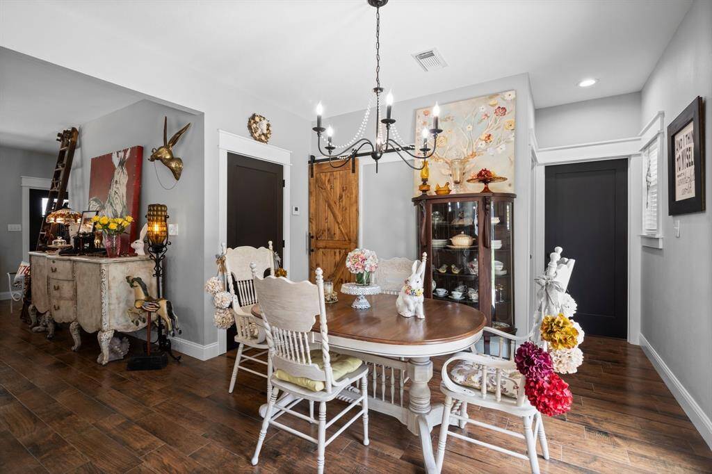 Pantry behind the wooden sliding door.  The black door to the left of the pantry is a great sized storage closet.  The black to to the far right leads into the laundry room which is connected to the primary closet and primary bath! This home is tidy and efficient!