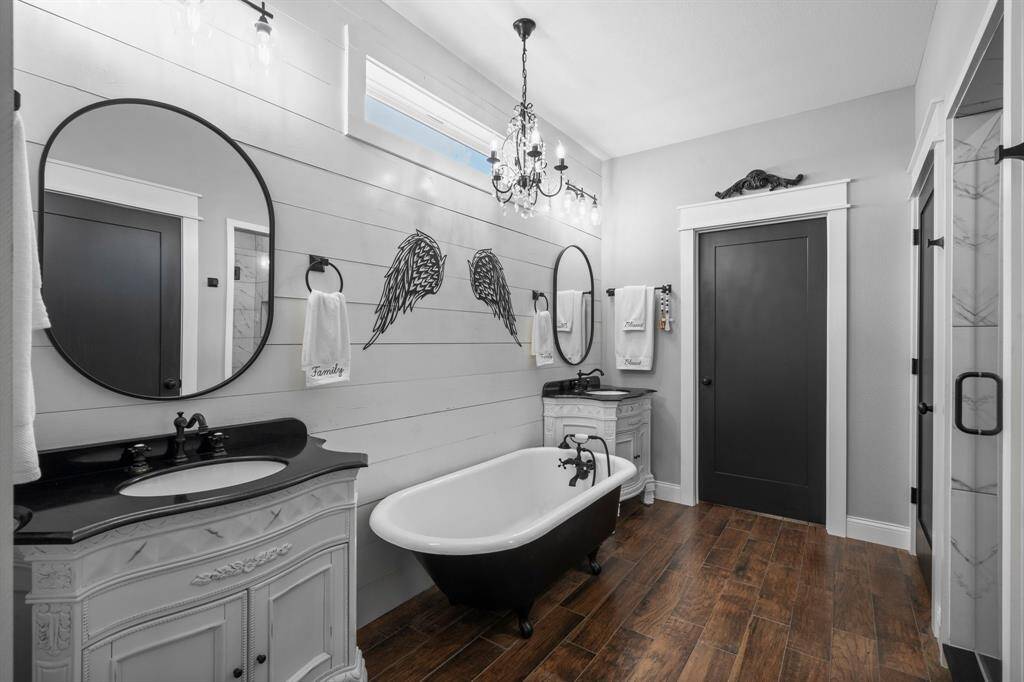 The perfect mix of modern and antique in this awesome primary bathroom! The tub truly is an antique!