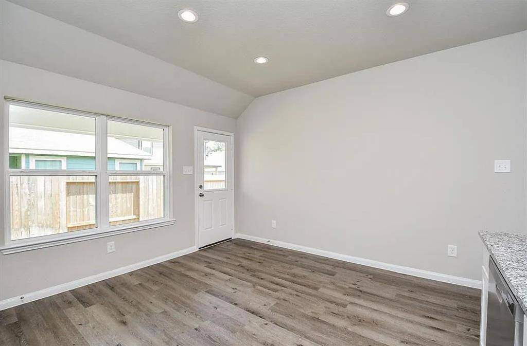 Expansive breakfast area with contemporary lighting, perfect space for entertaining.