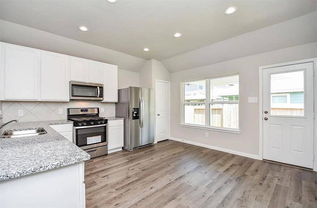 Contemporary kitchen with sleek cabinetry, granite countertops, and ample storage.