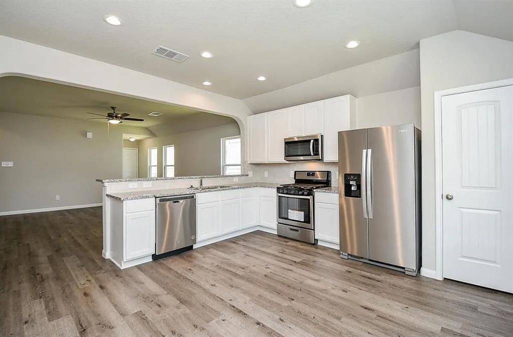 Another view of the kitchen featuring stainless steel appliances.
