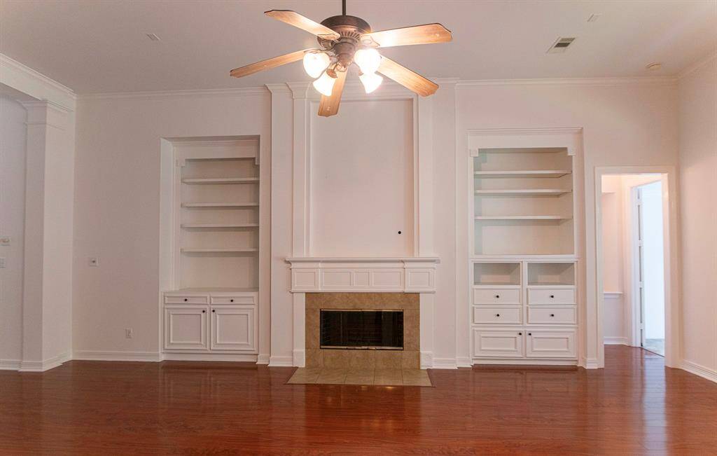 Sensational family room  providing a fabulous gathering place with fire place, built in shelves with mounted lights and ceiling prewired for your sound system entertainment.