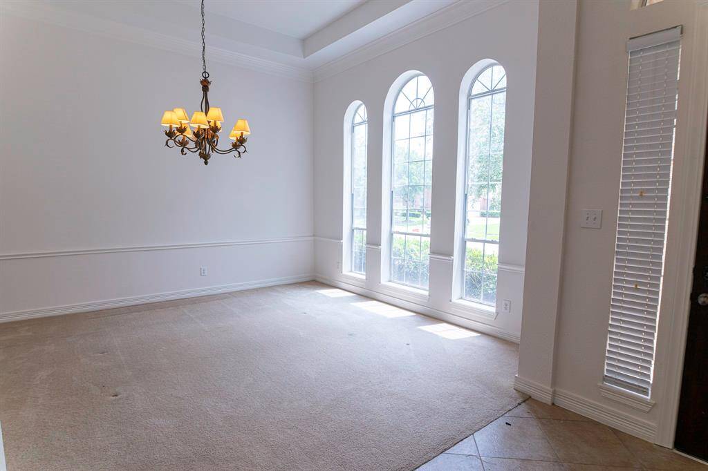 Formal dining with arched windows bringing all the natural sunlight with beautiful outdoor view.