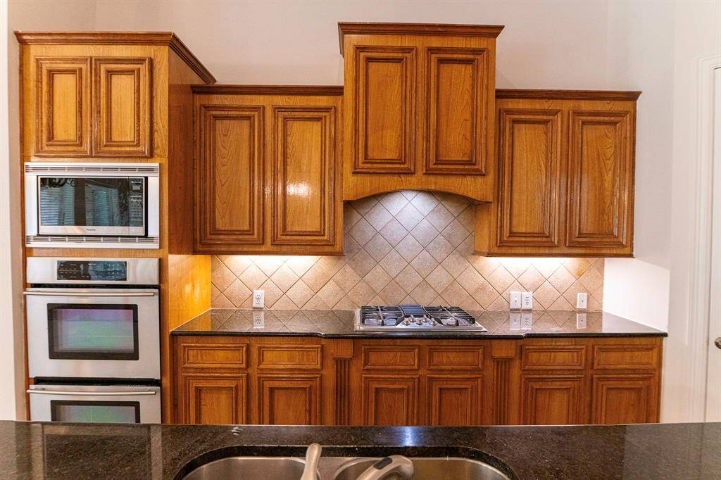 The gourmet kitchen brings together exquisite counter space including the huge island, recessed lightning and stainless steel appliances including Cook top dishwasher sink and double oven.