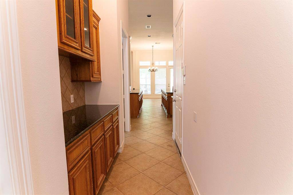 Butlers pantry with lots of cabinets.