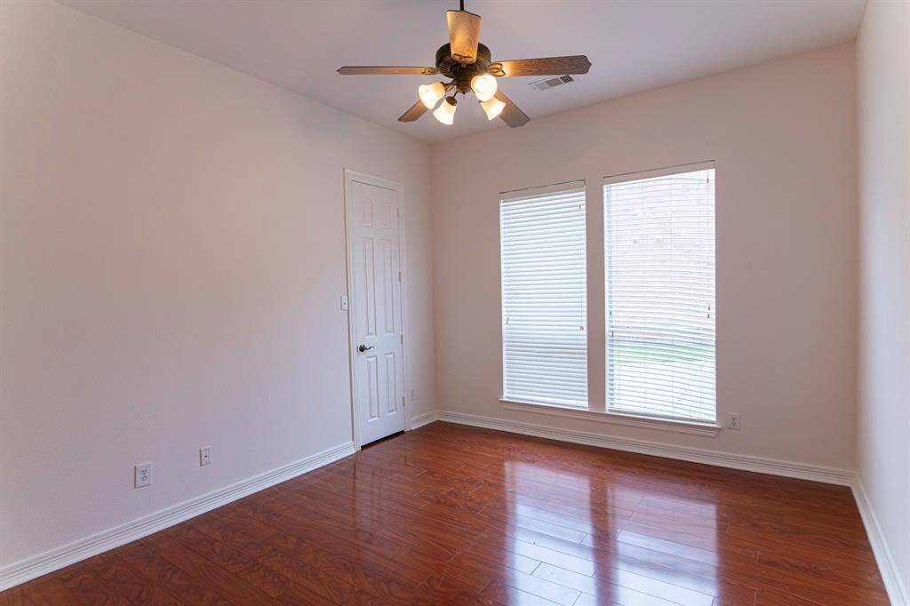 Bedroom 2 with walk in closet and laminate flooring.