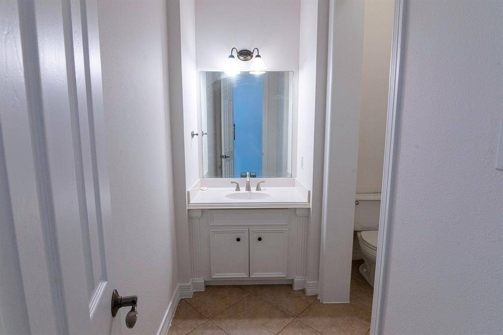 Powder room conveniently located next to formal dining perfect for your guests.