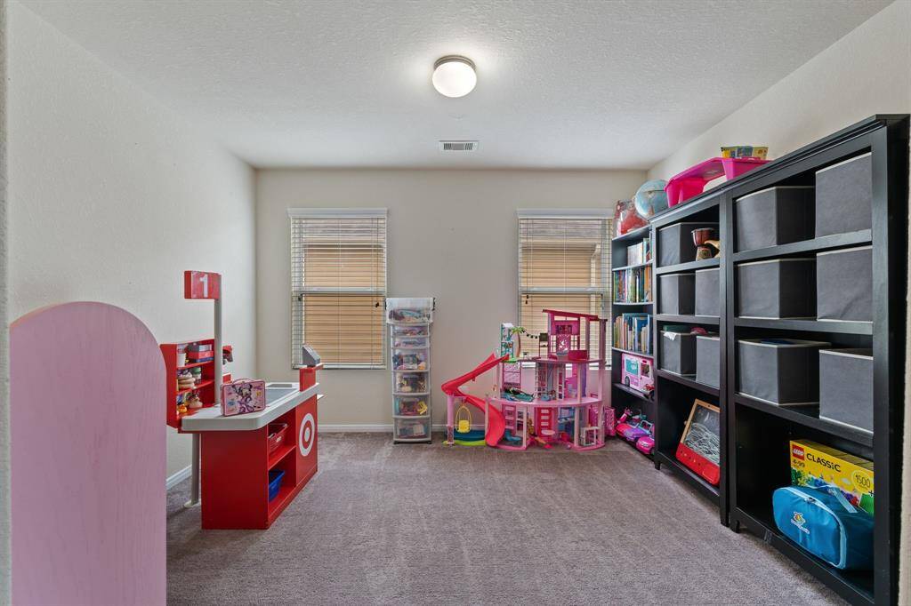 Across from the media is the home office that is currently being used as a play room.
