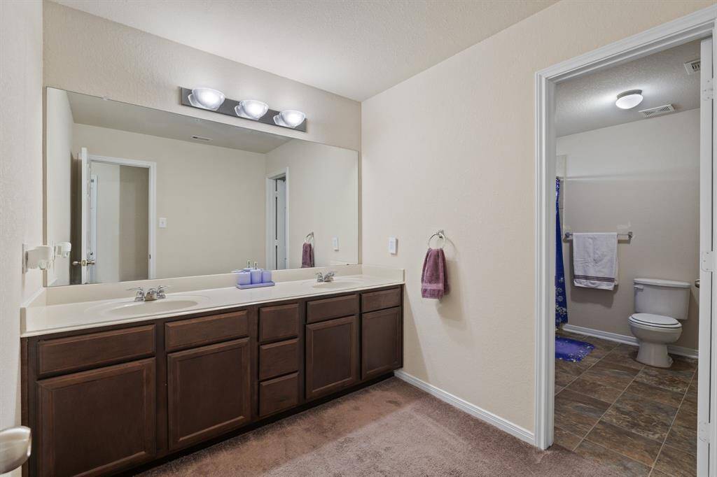 The large upstairs secondary bathroom has a separate sink area from the shower/tub.