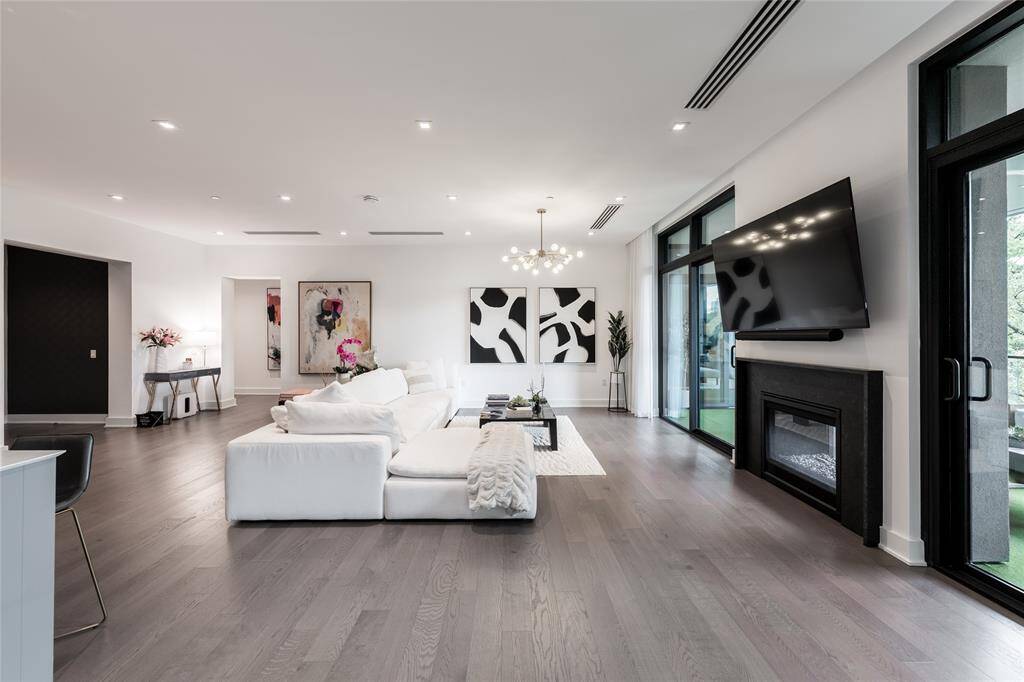 Enjoy a double-sided fireplace and a spacious living area that seamlessly flows into the enclosed loggia.