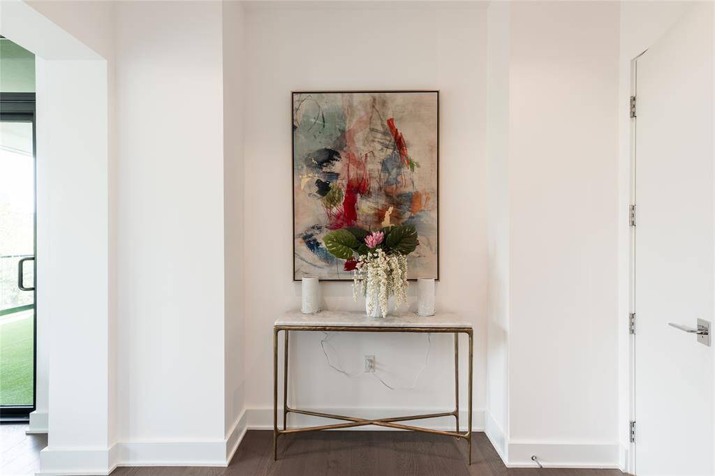 A gracious foyer leads to the expansive primary suite, which features direct access to a private loggia, providing seamless indoor-outdoor living.