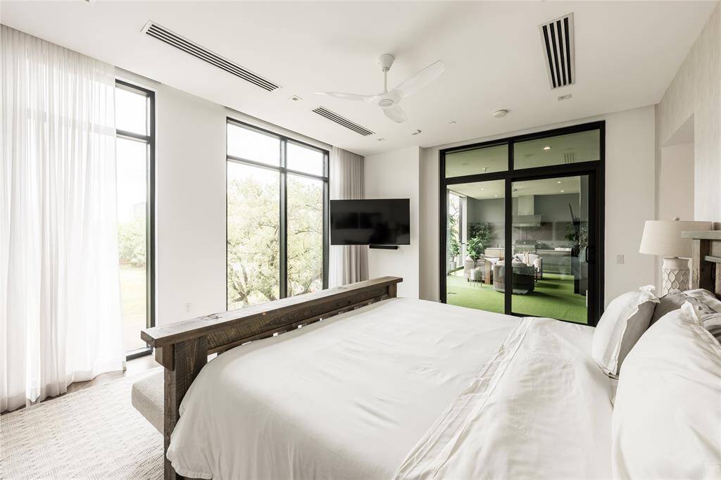 An expansive and stunning alternative view of the luxurious primary retreat, offering a seamless transition to the private loggia, perfect for indulgent indoor-outdoor living.