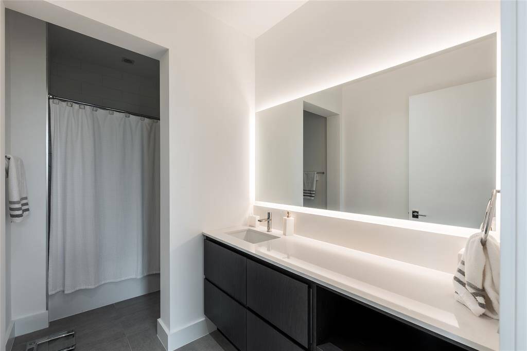 Light framed mirror, tub/shower for the secondary ensuite.