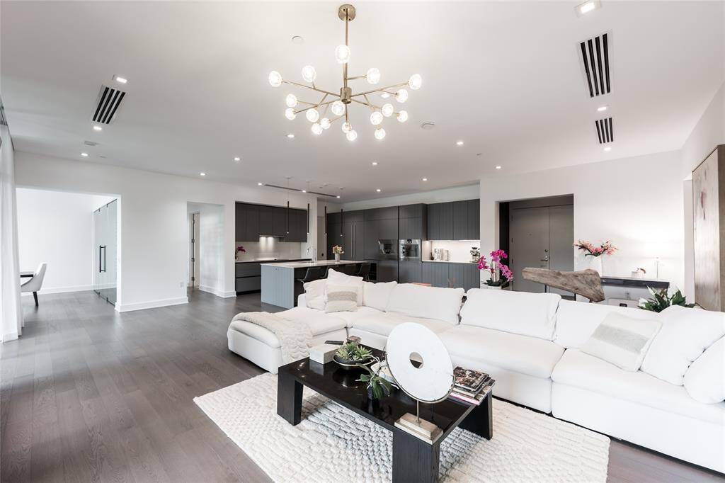 An inviting ambiance is anchored by a stunning double-sided fireplace, seamlessly blending warmth and sophistication, perfect for effortless entertaining in this Giorgetti masterpiece.