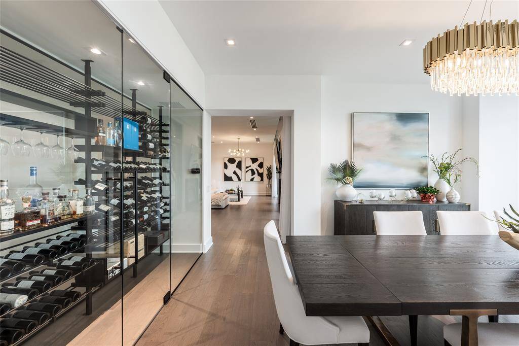 Spacious formal dining room, perfect for entertaining, paired with an elegant, climate-controlled glass wine cellar.