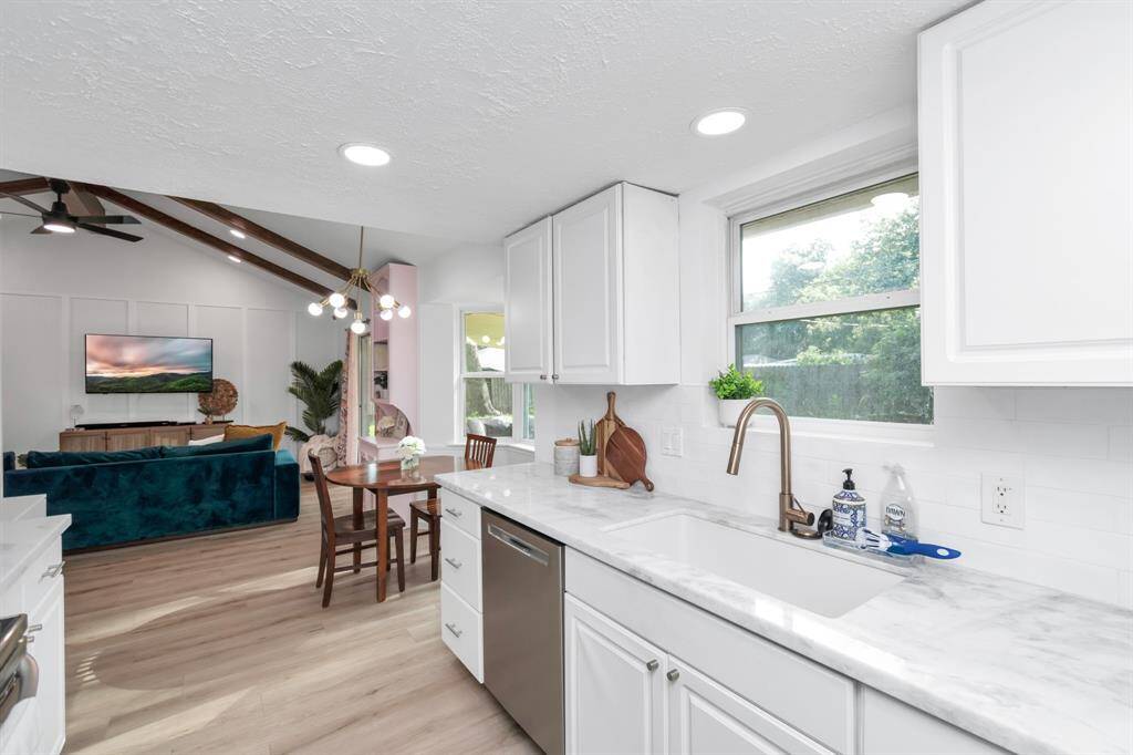 The large kitchen with dolomite countertops and stainless steel appliances is perfect for entertaining, while the spacious living area offers plenty of room for family gatherings or relaxation