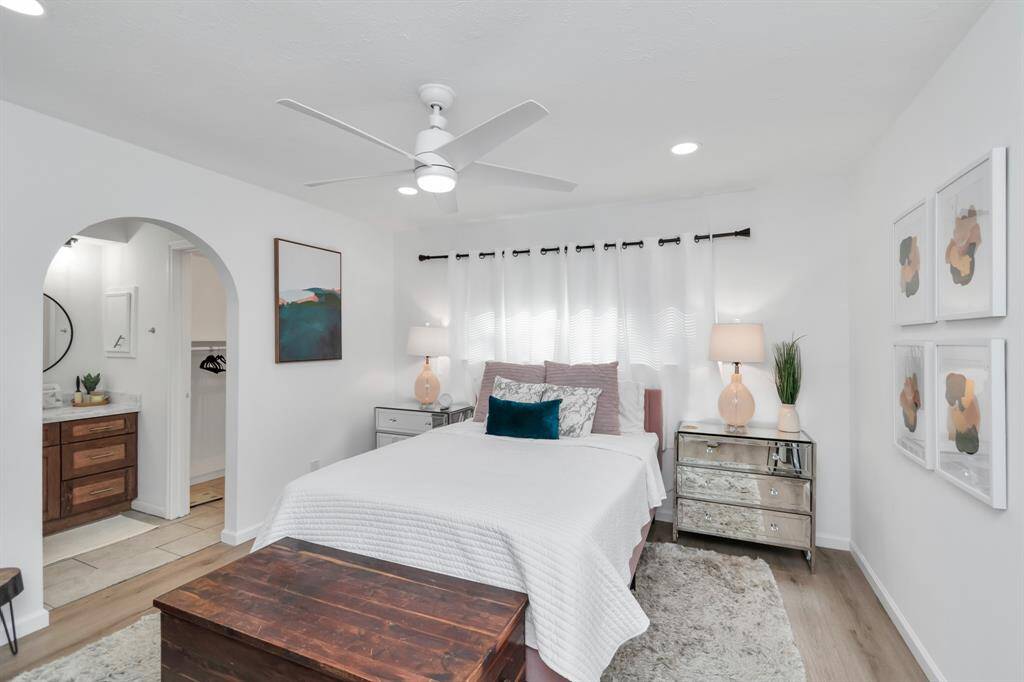 This primary bedroom is a spacious and serene retreat, offering ample room for relaxation. The calming design, paired with large windows, lets in an abundance of natural light, creating the perfect space to unwind after a long day.