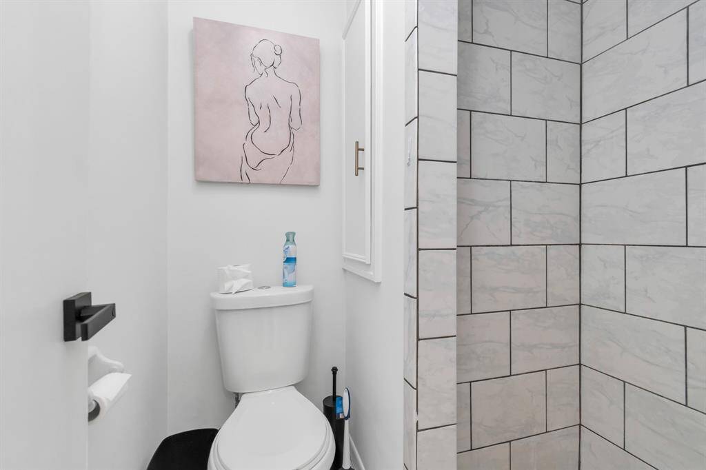 The primary bedroom features a peaceful, open design with a private ensuite bathroom that includes a walk-in shower.