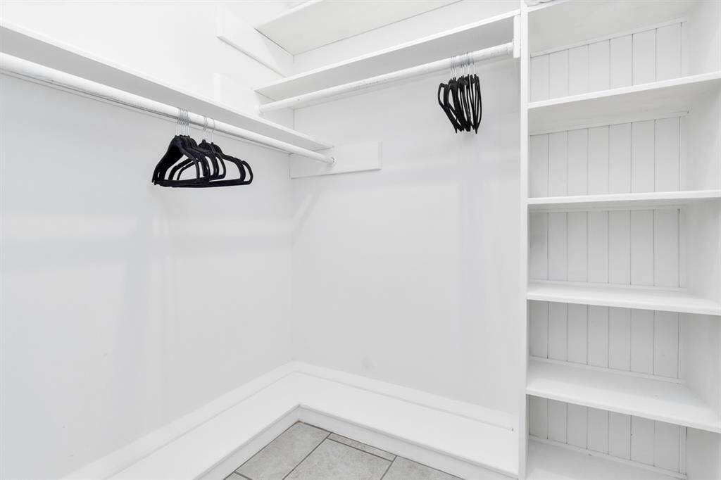 The primary walk-in closet offers an abundance of space, featuring custom shelving and hanging areas to keep your wardrobe organized and easily accessible. With plenty of room for shoes, clothes, and accessories, this closet is the perfect blend of style and functionality.