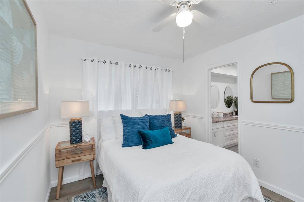 The secondary bedroom features plenty of space for furniture and personal touches. Just steps from the Jack and Jill bathroom, it offers easy access to the dual-sink vanity and tub-shower combo, making it both practical and comfortable.