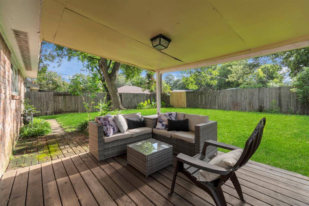 Step outside to a serene backyard featuring a covered patio and a cozy seating area—perfect for relaxing or entertaining. Whether you're enjoying a morning coffee or hosting friends, this outdoor space offers comfort and tranquility.