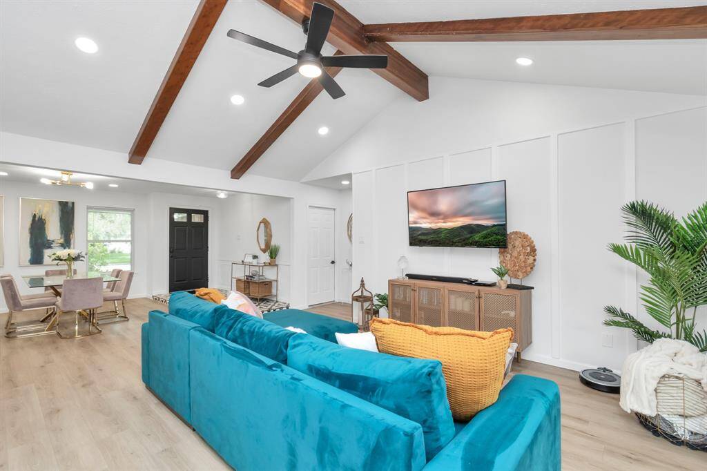 With beamed vaulted ceilings and an open-concept design, this living room exudes charm and sophistication. The space feels both spacious and intimate, making it ideal for everything from cozy nights to hosting friends and family.