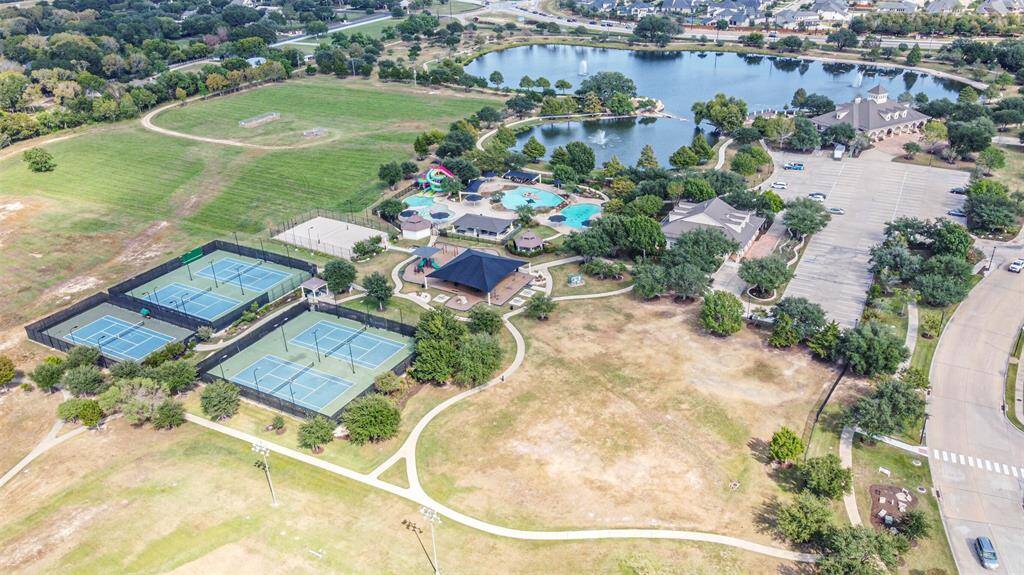 Community center with tennis courts, pools, covered playground, walking trails around the lake