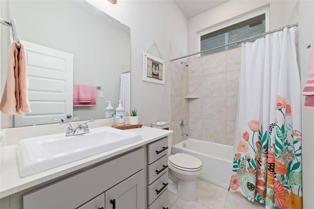 BATHROOM 3 RIGHT OUTSIDE OF THE FRONT BEDROOM
