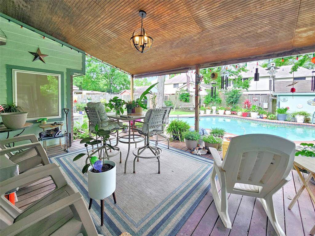 Large covered deck with stained beadboard ceiling.