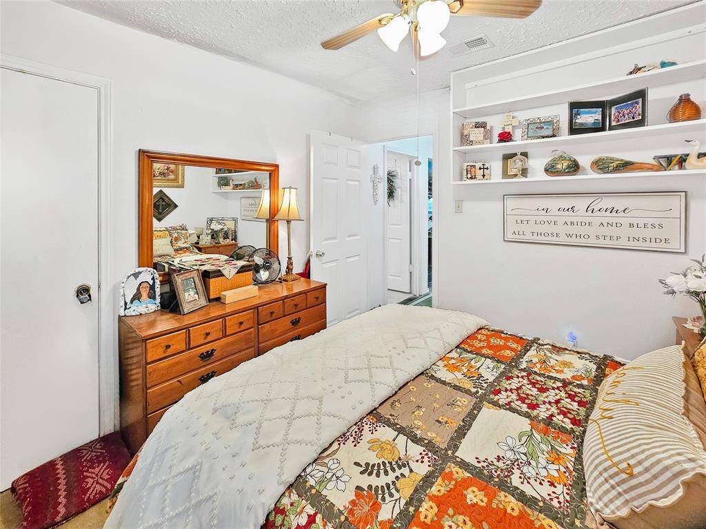 Walk-in closet and built-in shelves on the wall.