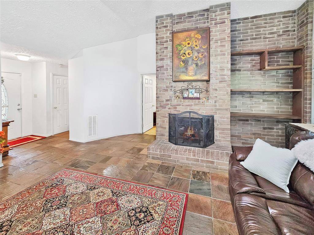 Additional storage off the entry/garage area as well as built-in shelving by the fireplace.