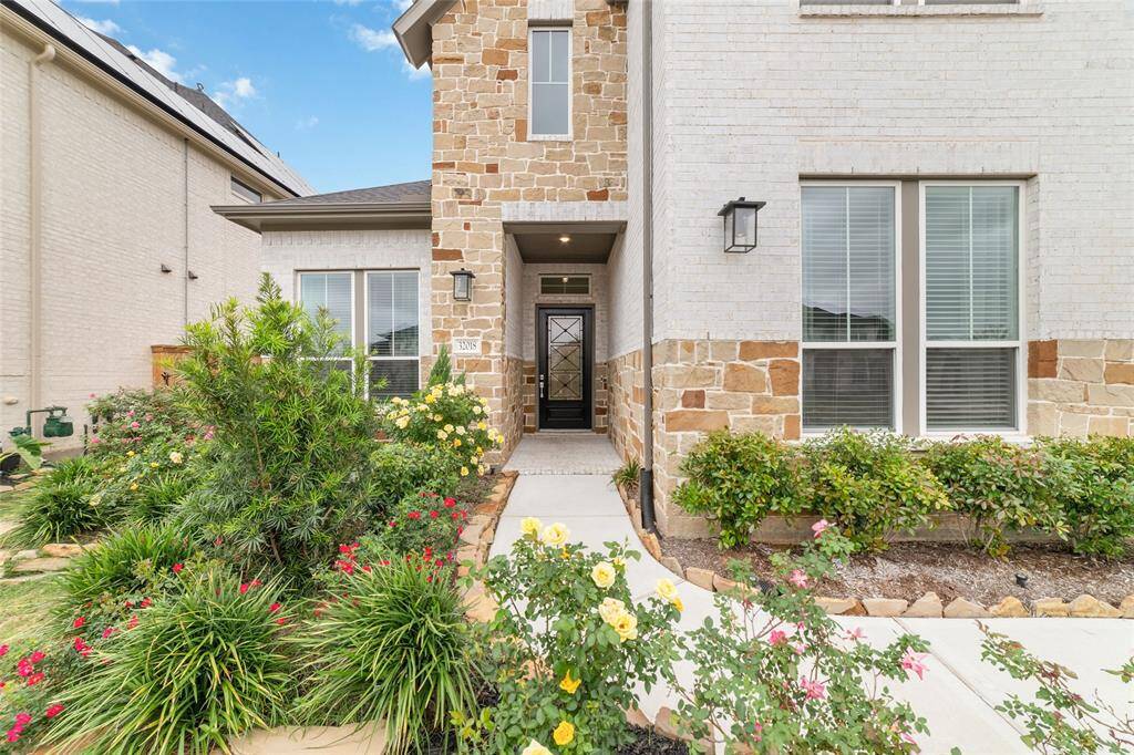 Close-up of the front facade showing the blend of stone and brickwork that adds character and timeless beauty to the home.