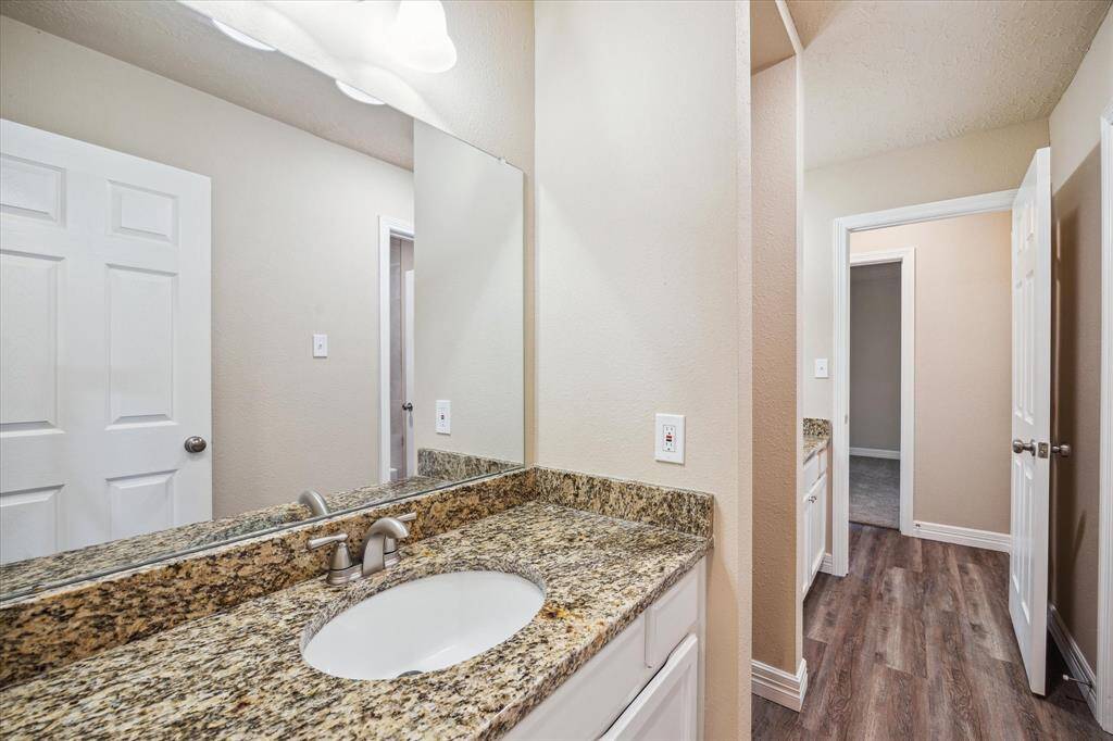 Spacious dual sinks enhance convenience in the second bathroom.