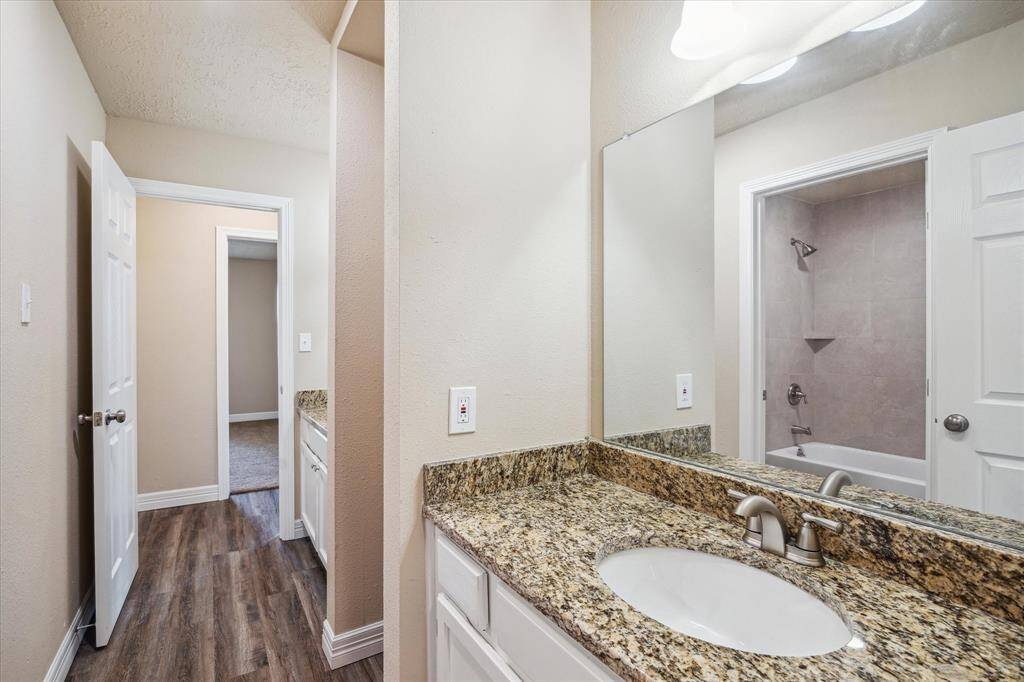 Beautiful granite countertops and dual sinks enhance the second bathroom.