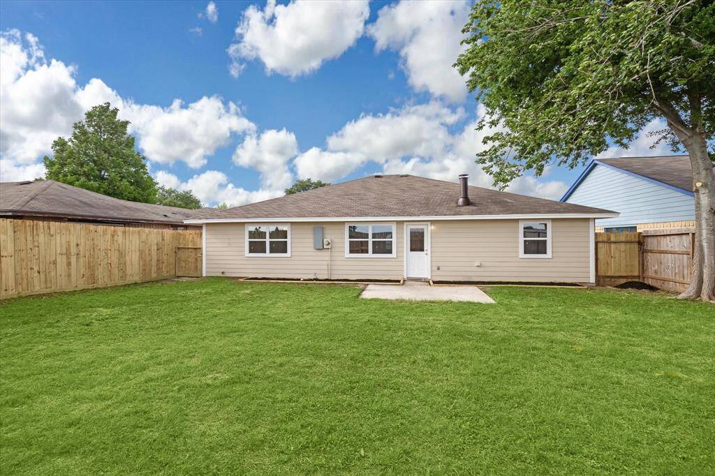 Expansive backyard view highlighting the home's welcoming exterior.