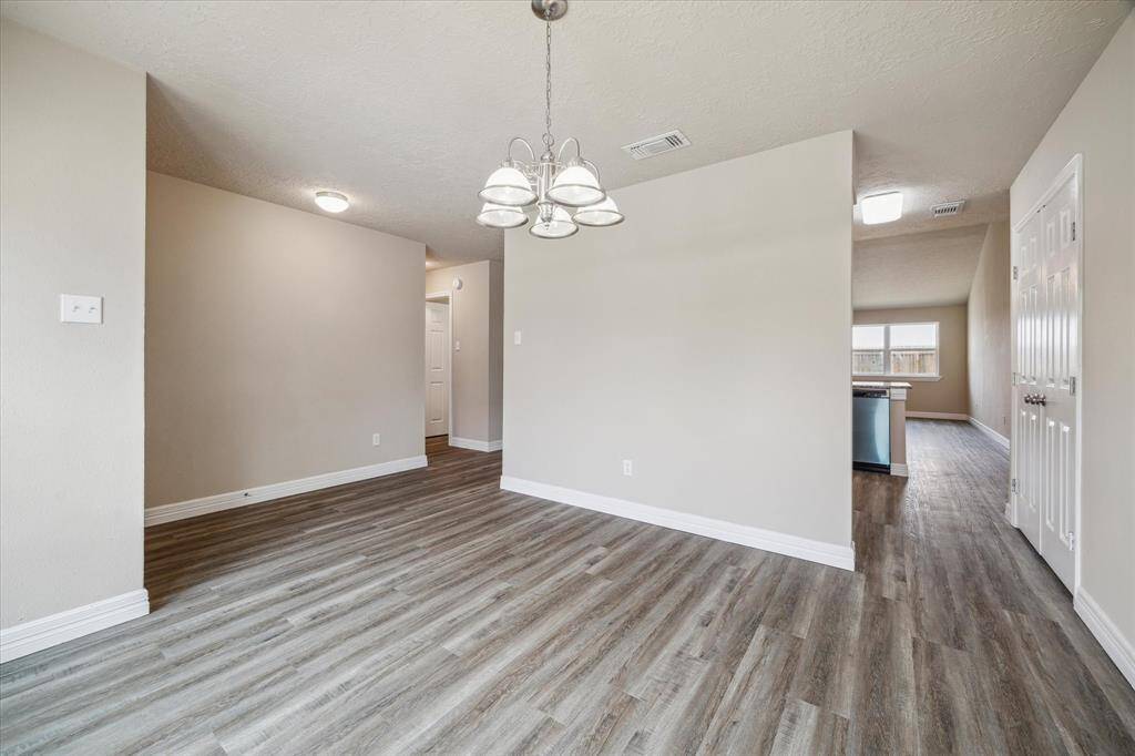 Step into an inviting open layout seamlessly connecting the dining area, kitchen, and living room.