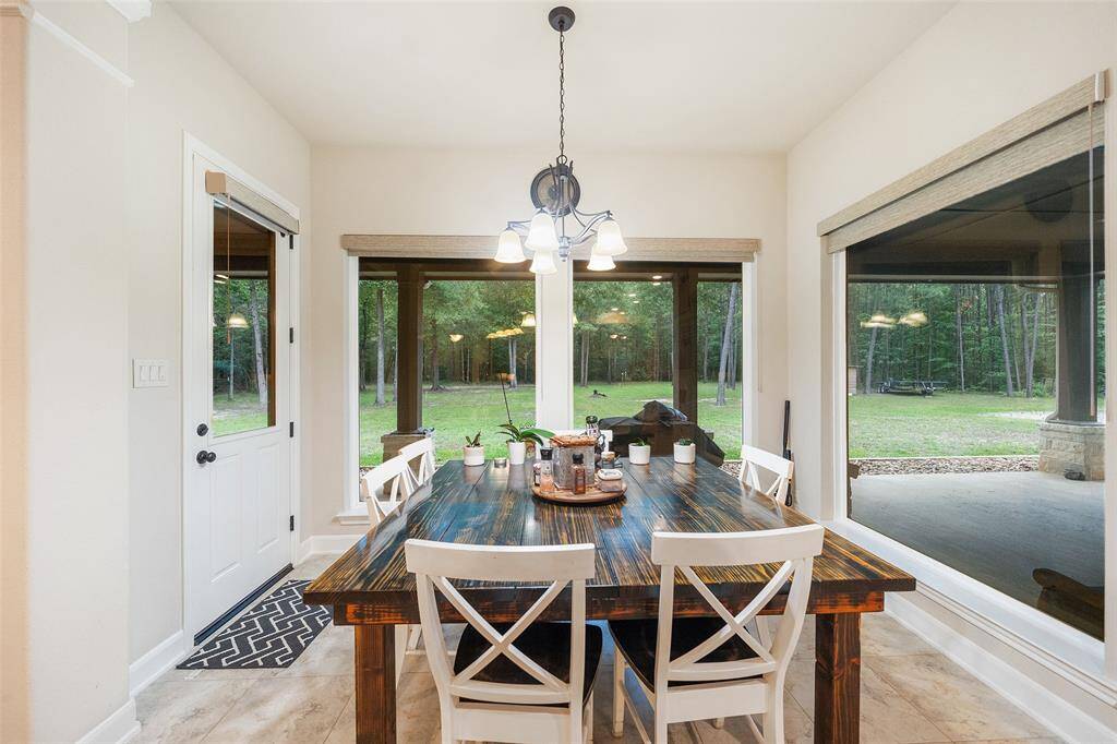 Enjoy your morning coffee or a laid-back dinner with a view in this bright and airy dining space. Surrounded by oversized windows that overlook the wooded backyard, it's the perfect space to slow down and savor the moment.