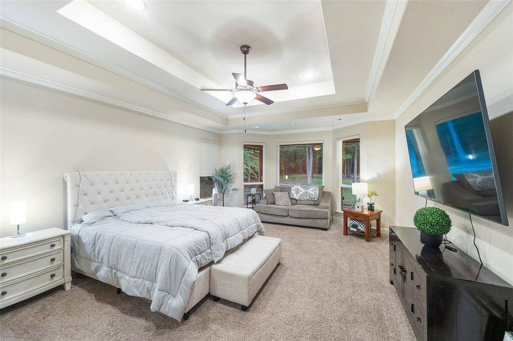 You’ll have sweet dreams in this spacious primary suite with a raised tray ceiling, soft carpet underfoot, and a cozy sitting area surrounded by bay windows. Two walk-in closets and a private ensuite bath make this a space you’ll look forward to coming home to.