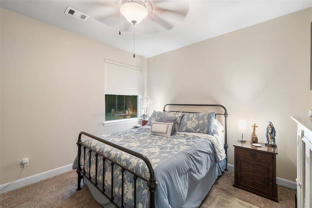 Your family and guests will rest comfortably in this spacious guest suite featuring soft neutral finishes, a large closet, and ensuite access to a shared full bathroom.
