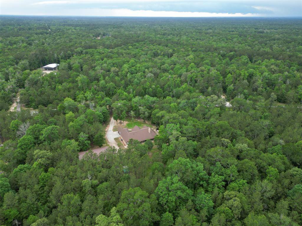 From above, you can truly see the magic. This home is tucked deep into the trees with nothing but treetops and sky in every direction. It’s the kind of privacy and serenity that’s hard to find and even harder to leave.