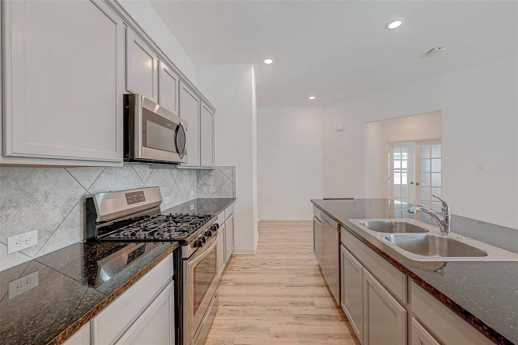 From the kitchen you can see the office to the right through the French doors.