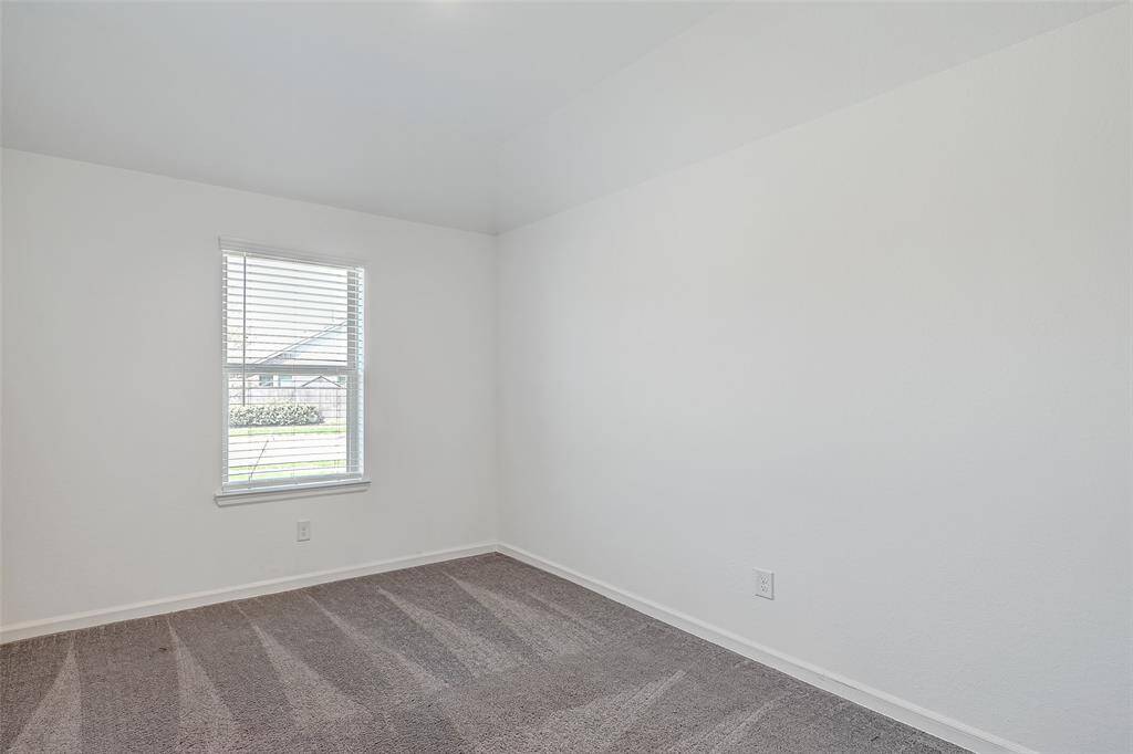 The secondary bedroom is at the front of the home and offers plenty of natural light.