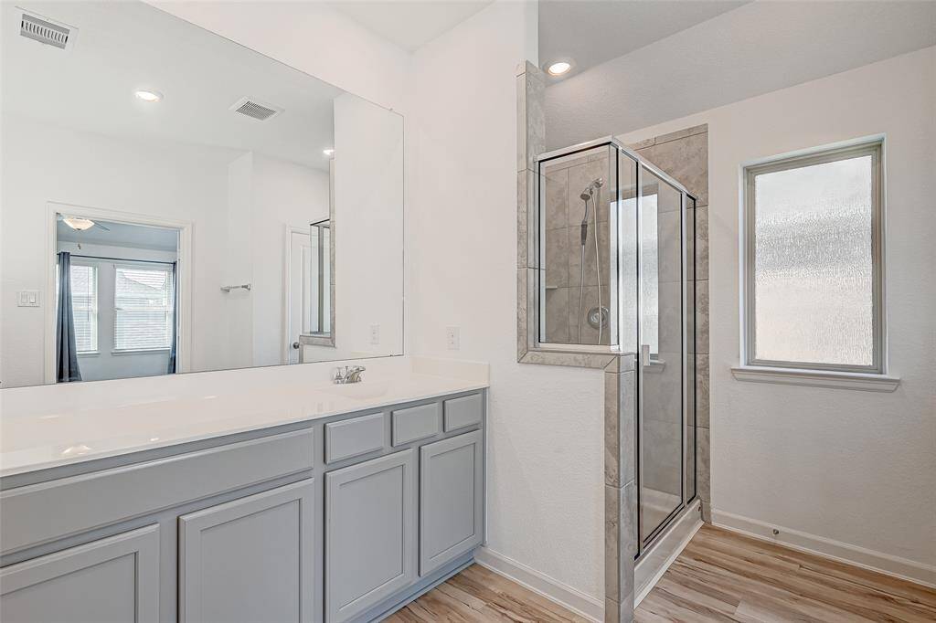 Relaxing primary bathroom with a huge walk-in shower.