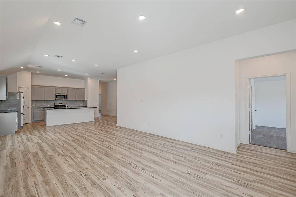 The primary bedroom is just off to the right, and your kitchen is open to the rest of the living area.
